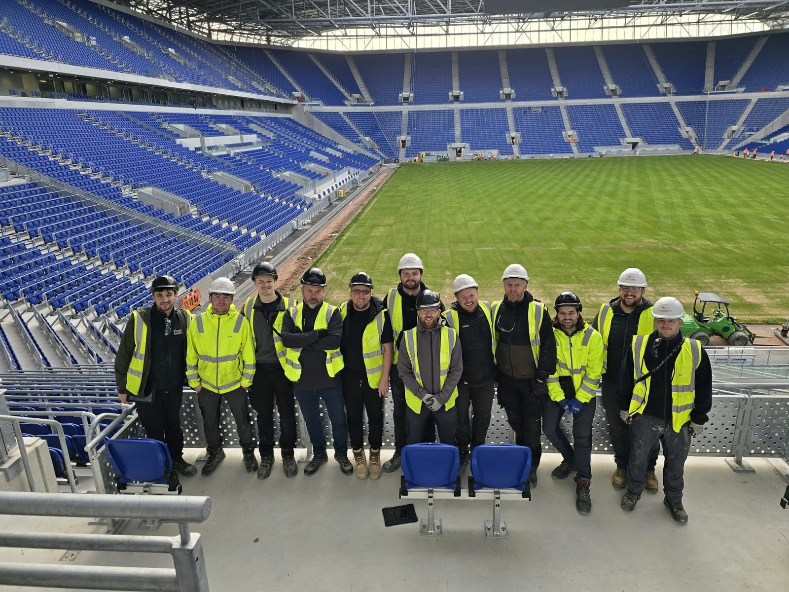 The Firesafe Installations site team gathered in the stands of the stadium project they worked on